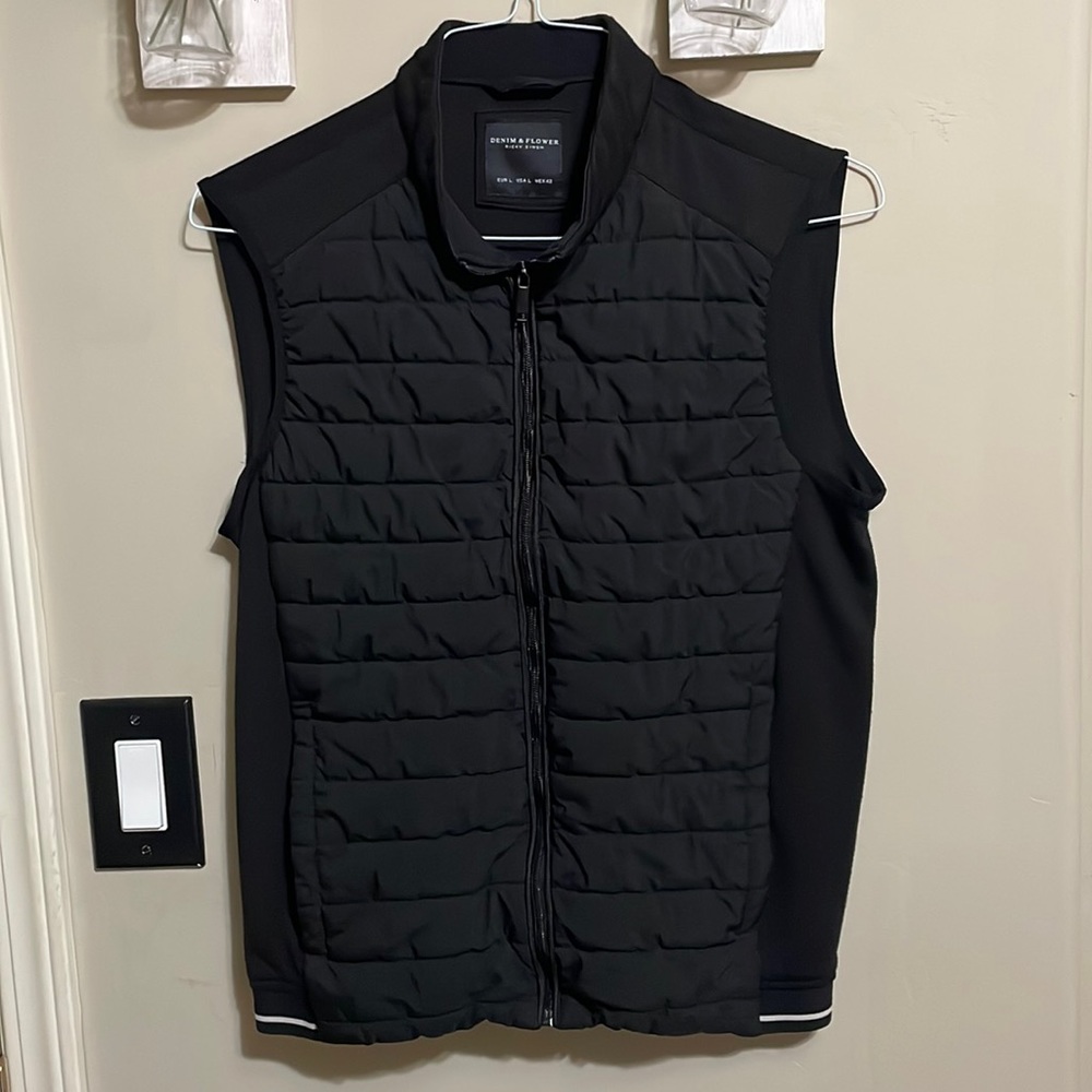 Black vest kids size L , zipper has some waves , when closed pictures shows